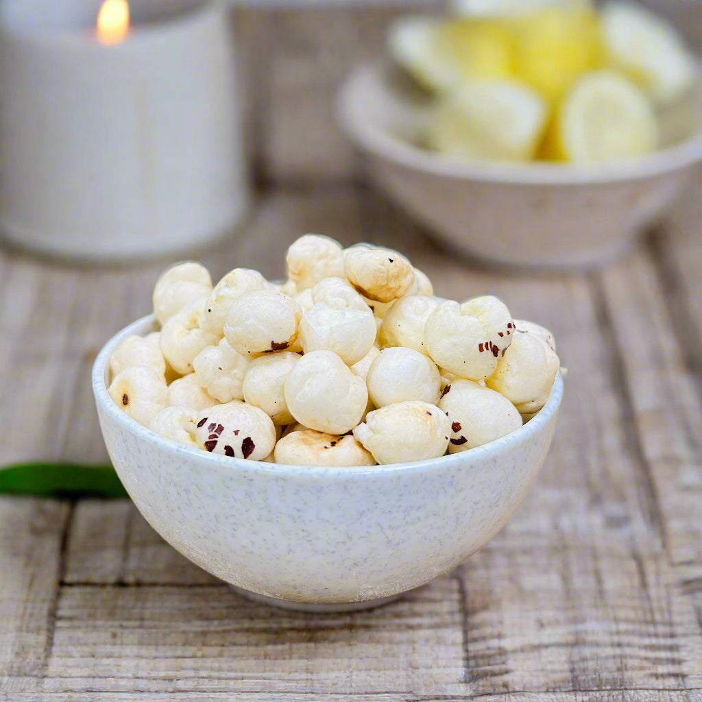 Bowl of white roasted makhana on wooden surface illustrating the rising price of makhana in the market