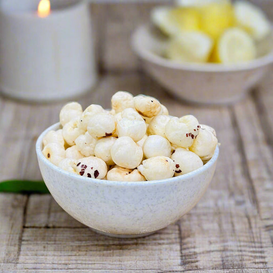 Bowl of white roasted makhana on wooden surface illustrating the rising price of makhana in the market