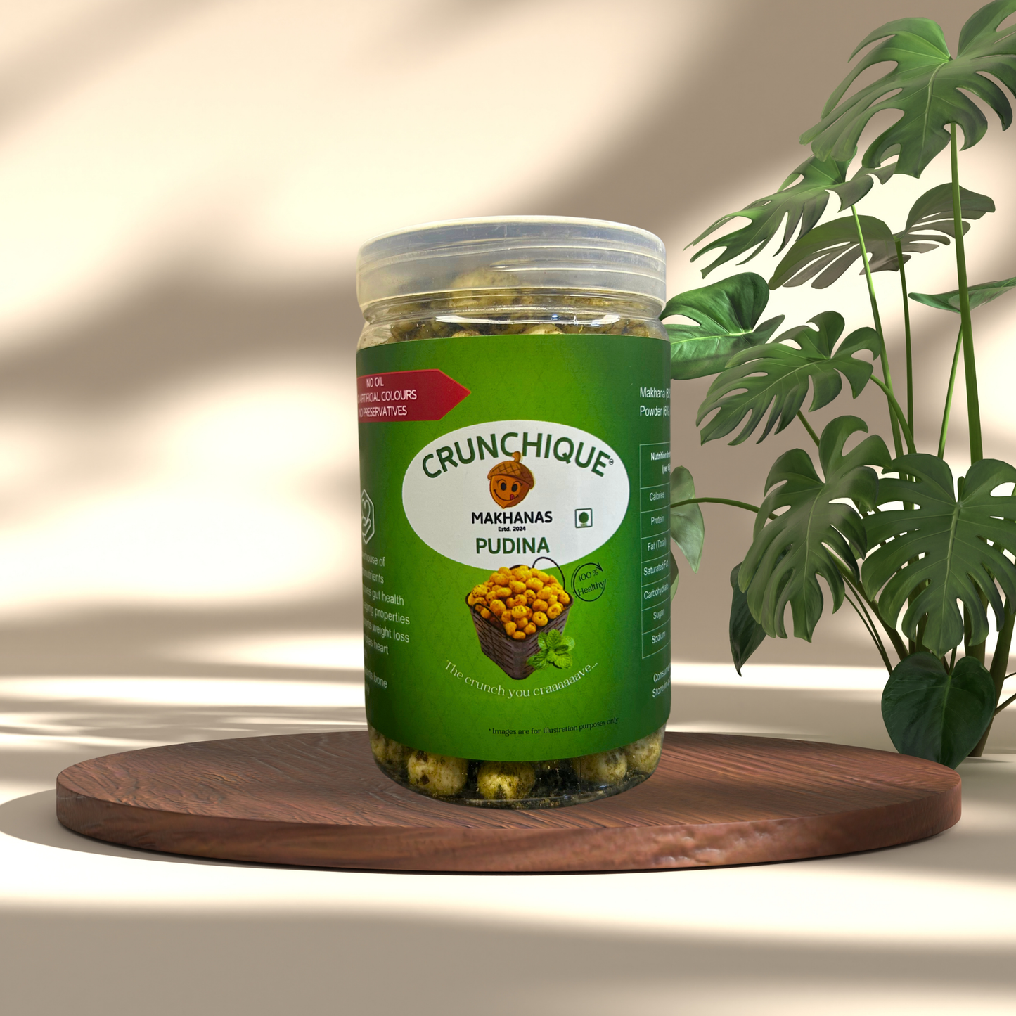 Crunchique Pudina Makhana pack with natural seasoning on wooden platter next to green plant